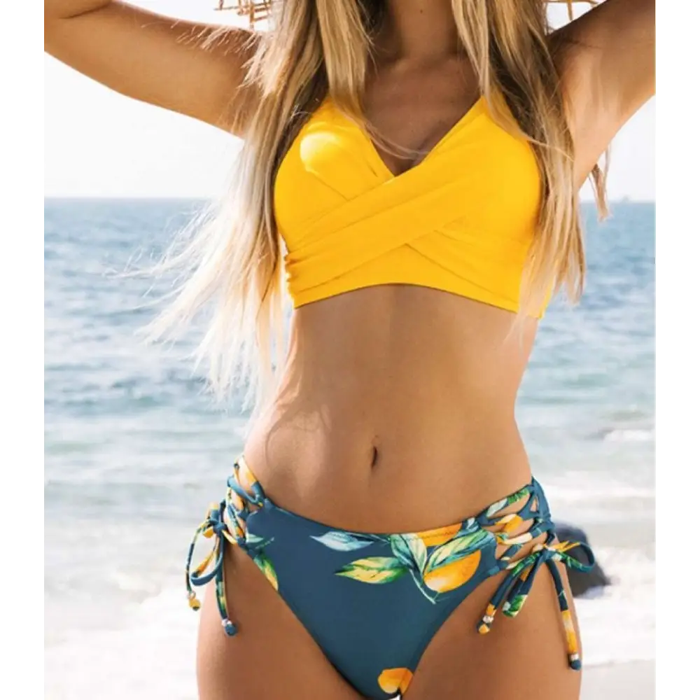 Bright yellow citrus print yellow bikini swimsuit with cross front top and teal side tie bottoms
