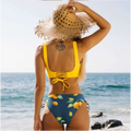 Yellow bikini swimsuit with citrus print yellow and navy blue two-piece featuring a bright yellow lace-up back