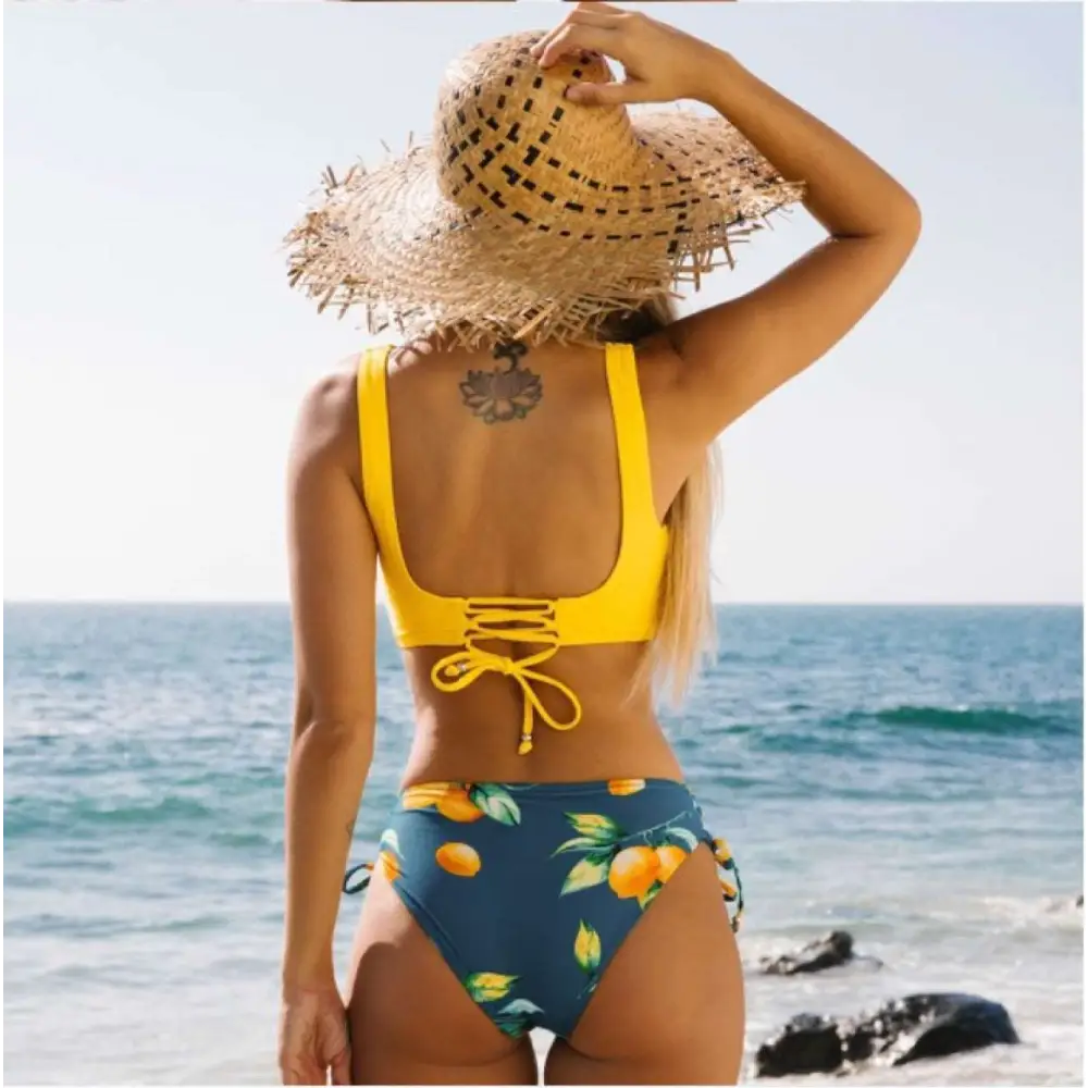 Yellow bikini swimsuit with citrus print yellow and navy blue two-piece featuring a bright yellow lace-up back