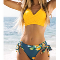 Bright yellow citrus print yellow bikini swimsuit with cross-front top and side-tie bottoms in teal accents