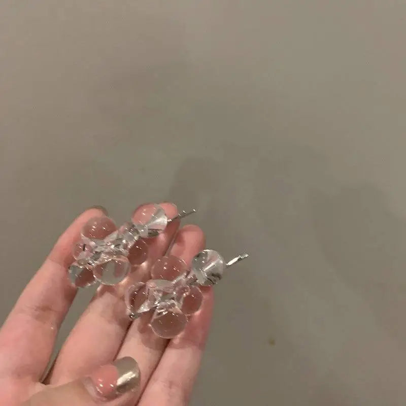 Clear acrylic beaded clip earrings with faceted glass beads and silver metal clasp posts for elegant wear