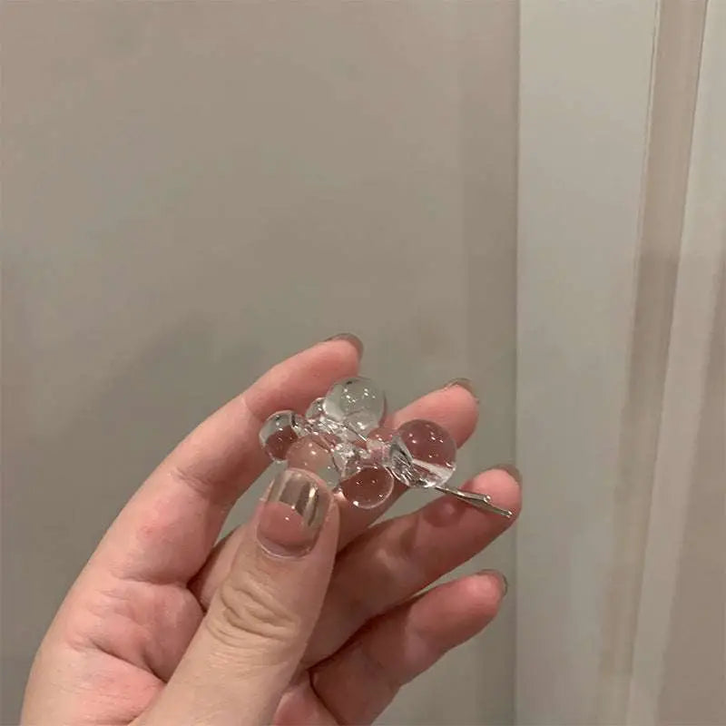 Clear acrylic beaded clip earrings with transparent glass beads and a silver metal clasp for elegant styling