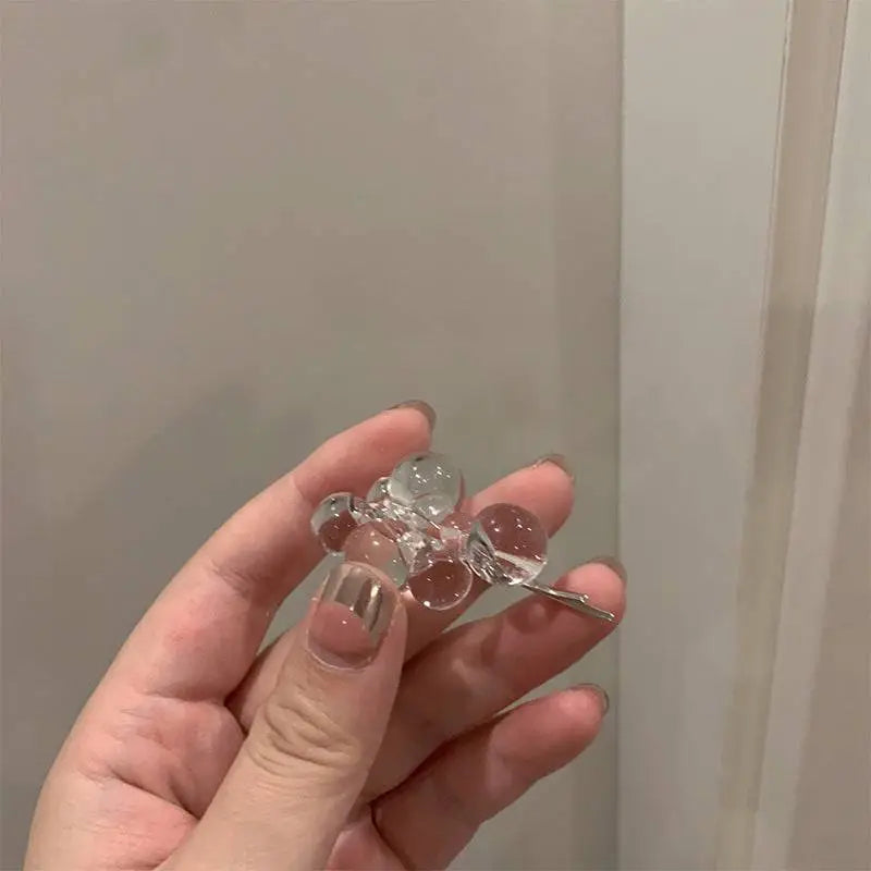 Clear acrylic beaded clip earrings featuring a clear glass bead design with a silver metal clasp and minimalist style