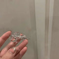 Clear acrylic beaded clip earrings featuring clear glass beads and a delicate silver metal clasp detail