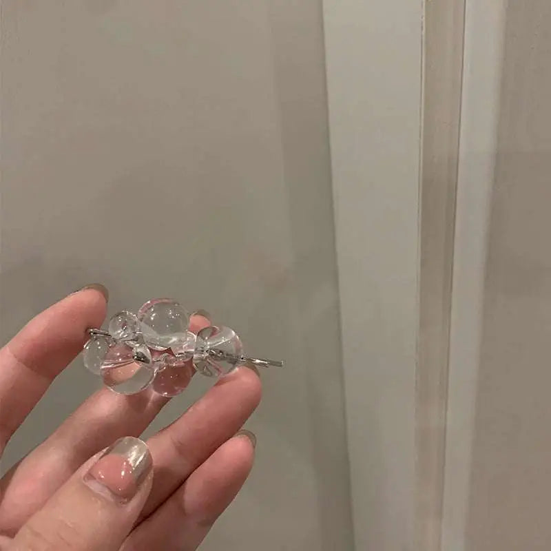 Clear acrylic beaded clip earrings featuring clear glass beads and a delicate silver metal clasp detail