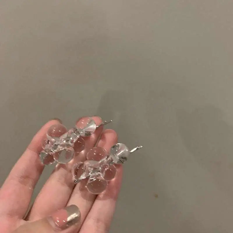 Clear acrylic beaded clip earrings with translucent glass beads and silver metal clasp in a delicate cluster design