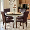 Round dining table with dark wood top and white pedestal base surrounded by colamy upholstered parsons dining chairs set of four