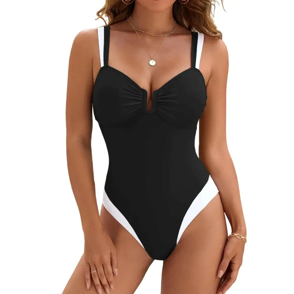 Black and white color block tummy control one-piece swimsuit with thin straps, ruched bust, and high cut legs