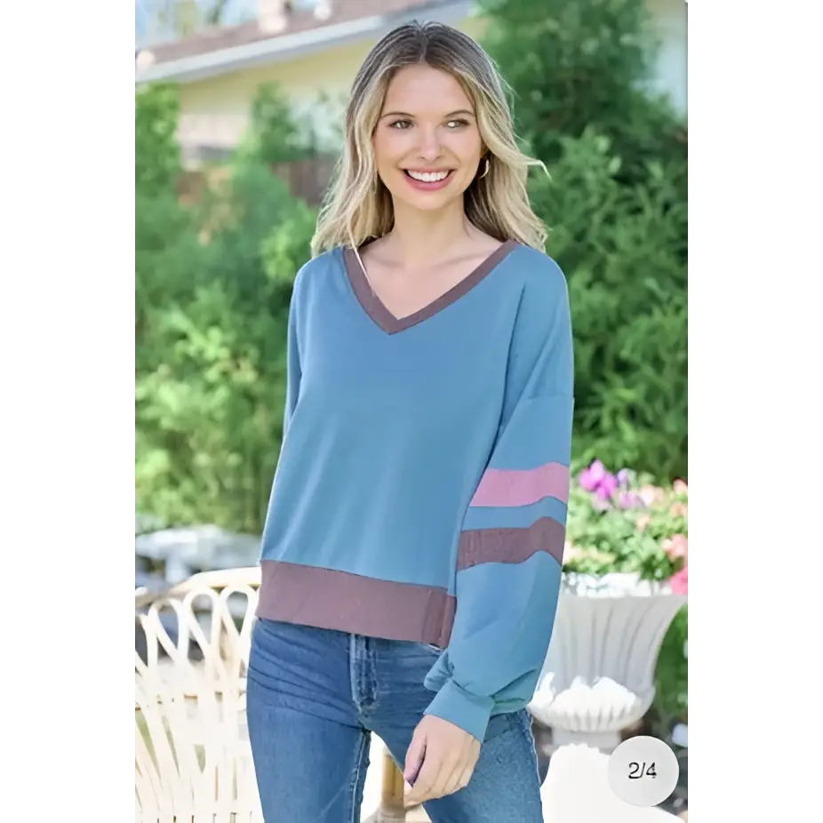 A soft blue and maroon striped color block v-neck cropped sweatshirt with long sleeves in a soft teal color