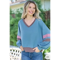 Blue cropped sweatshirt with color block v-neck in soft teal featuring brown and pink stripes on sleeves and hem