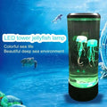 Color changing led jellyfish lamp with a cylindrical black base featuring glowing translucent green led jellyfish suspended in liquid