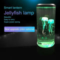 A sleek transparent led jellyfish lamp with glowing green internal lighting and two translucent jellyfish figures