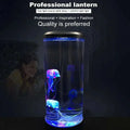 Transparent cylindrical led jellyfish lamp with glowing blue and purple jellyfish and metallic silver lid for ambiance lighting