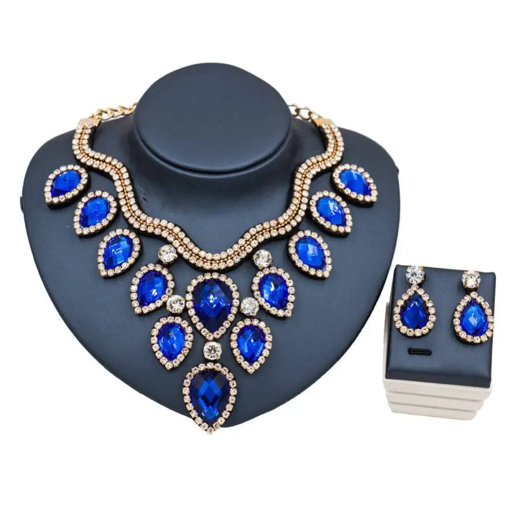 Colorful exaggerated bride necklace and earring set with blue teardrop gemstones gold-tone metal and diamond accents