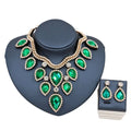 Emerald green teardrop exaggerated bride necklace and earring set with gold-tone metal and crystal accents on bust