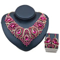 Colorful exaggerated bride statement necklace and earrings with fuchsia crystals and alloy color plating displayed on black bust