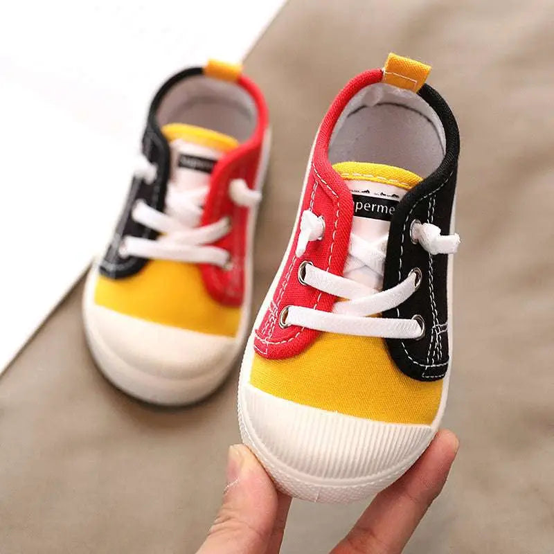 Colorful kindergarten indoor shoes featuring bright red and black canvas toddler sneakers with rubber soles designed for comfort