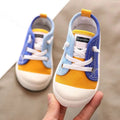 Blue and yellow canvas colorful kindergarten indoor shoes with white laces and ribbed white rubber soles designed for toddlers