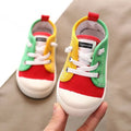 Colorful kindergarten indoor shoes with red yellow and green canvas panels and rubber soles designed for comfort