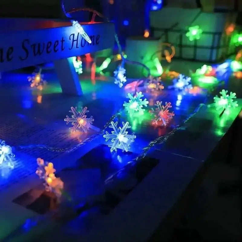 Colorful led snowflake lights glowing in blue green and white for festive indoor and outdoor decoration
