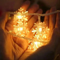 Warm glowing colorful led snowflake lights with clear plastic fixtures for festive decoration use