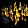 Colorful teardrop bubble garden solar lights featuring golden teardrop-shaped led string lights with multiple lighting modes and a black solar panel