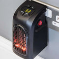 Black compact ceramic heating fan heater wall-mounted with red glowing elements and digital display showing 32 degrees
