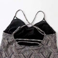 Black and white color split geometric one-piece swimsuit with crisscross shoulder straps in conservative artistic color style