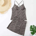 A stylish two-piece swimsuit set with color split geometric dark gray and black pattern and thin crisscross straps