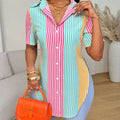 A vibrant short-sleeved contrast color striped asymmetrical hem shirt in pink teal and yellow vertical stripes