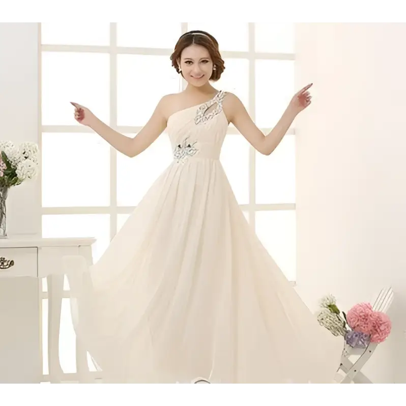 A flowing ivory chiffon evening dress with single-shoulder design and delicate beaded embellishments on the bodice