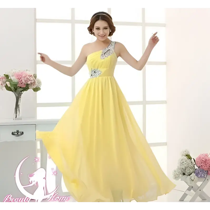 A flowing yellow chiffon evening dress with one-shoulder design and sparkling beaded embellishments on neckline