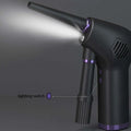 Dark gray cordless air duster and handheld vacuum cleaner with purple accents and narrow nozzle emitting light