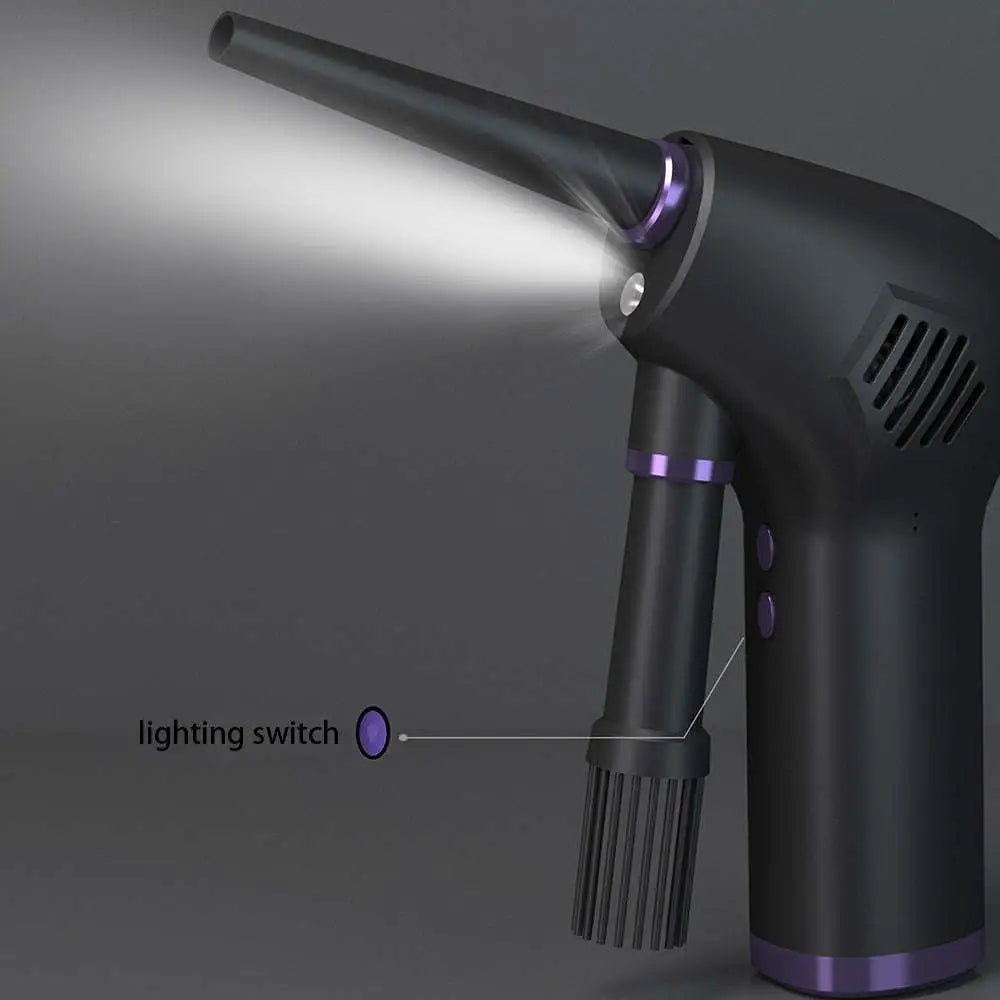 Dark gray cordless air duster and handheld vacuum cleaner with purple accents and narrow nozzle emitting light