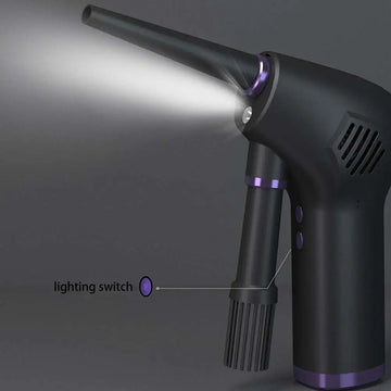 Dark gray cordless air duster and handheld vacuum cleaner with purple accents and narrow nozzle emitting light