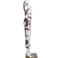 Women irregular hole cow print long-sleeved jumpsuit with bold black and white geometric pattern for stylish wear