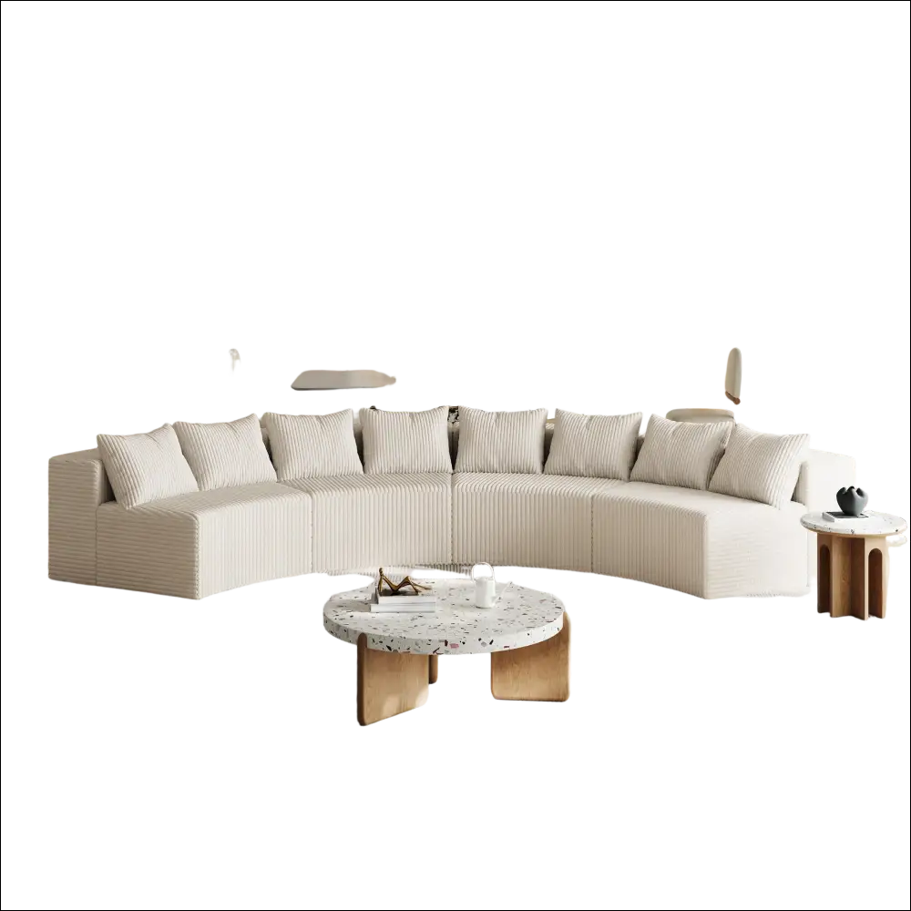 Cream corduroy curved sectional sofa in cream color with vertical ribbed texture and matching striped cushions