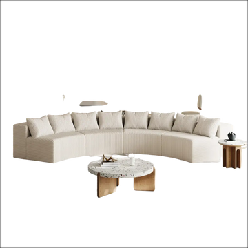 Cream corduroy curved sectional sofa in cream color with vertical ribbed texture and matching striped cushions