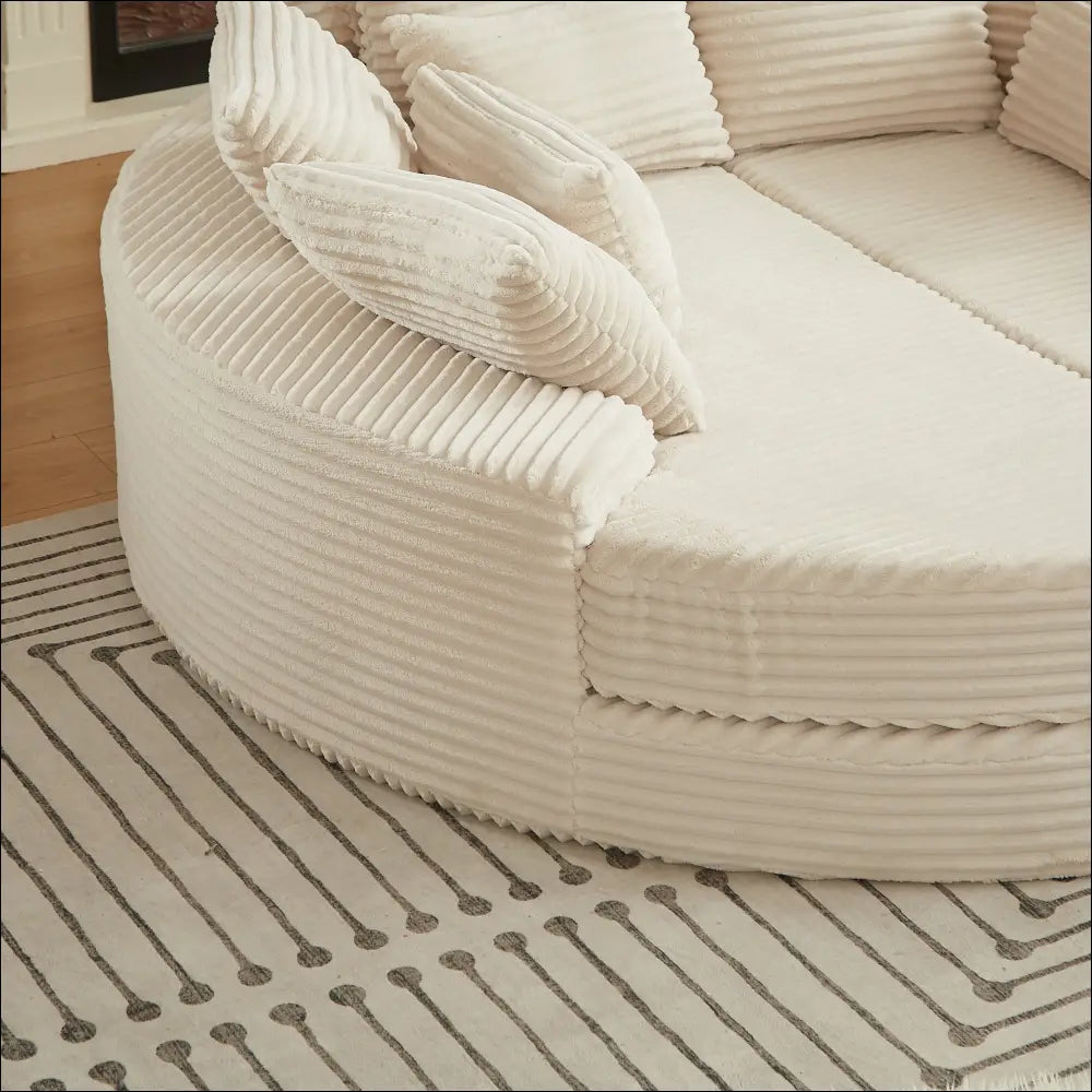Cream corduroy sectional sofa with matching ribbed cushions featuring round recliner neck pillow design