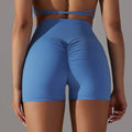 Blue high-waisted athletic shorts with ruched back design and pocket design fitness for versatile workout use