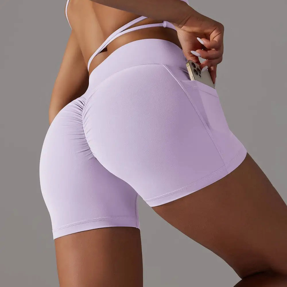 Lavender high-waisted athletic shorts with ruched back and side pocket pocket design fitness for active wear