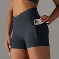 Dark gray high-waisted athletic shorts with pocket design fitness feature holding a smartphone for active use