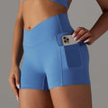 Light blue high-waisted athletic shorts with pocket design fitness feature holding a smartphone for active use