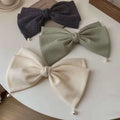 Three elegant bow barrettes spring clip in cream pearl large with navy and sage green textured fabric and pearl accents