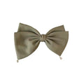 Olive green textured fabric bow tie with small metallic beads at tips paired with cream pearl large bow barrettes spring clip