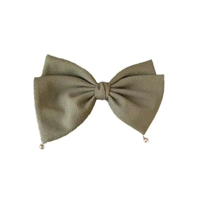 Olive green textured fabric bow tie with small metallic beads at tips paired with cream pearl large bow barrettes spring clip