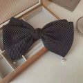 Cream pearl large bow barrettes spring clip featuring a black and white checkered fabric bow tie with pearl accents
