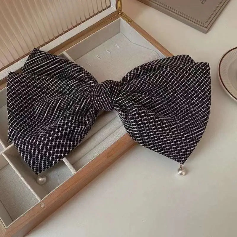 Cream pearl large bow barrettes spring clip featuring a black and white checkered fabric bow tie with pearl accents
