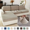 Cream stretchy universal sofa cover with beige herringbone pattern and textured woven fabric finish