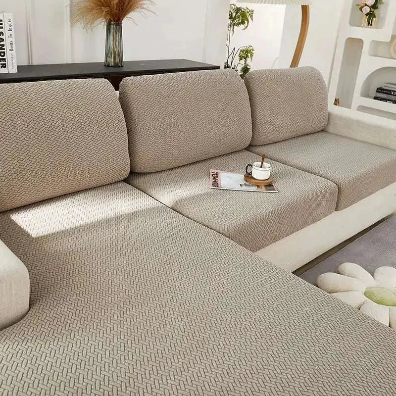 Cream stretchy universal sofa cover in beige with herringbone texture and woven fabric finish for versatile use